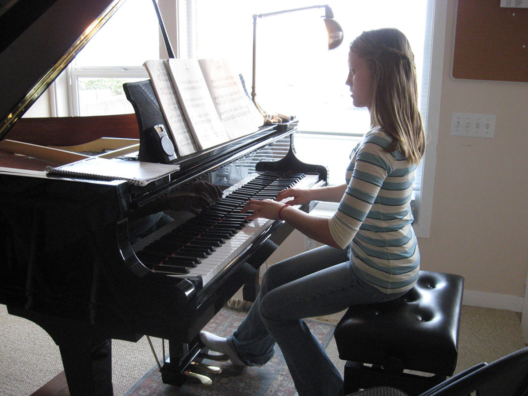 Photo of a young girl playing piano.