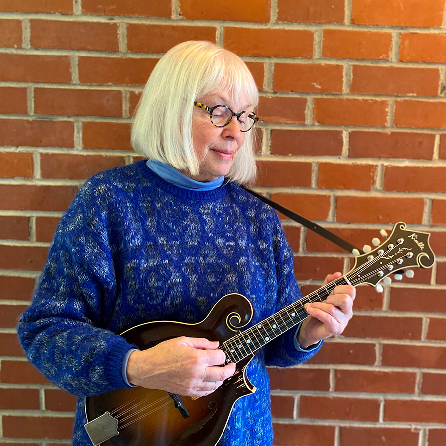 Photo of Grace Phelan playing a mandolin