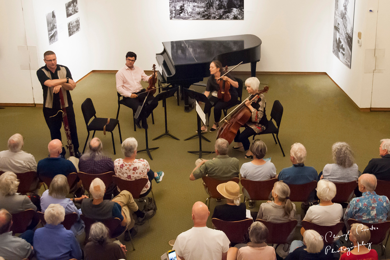 Overhead photo of a string quartet playing in front of an audience for a free concert in the community.