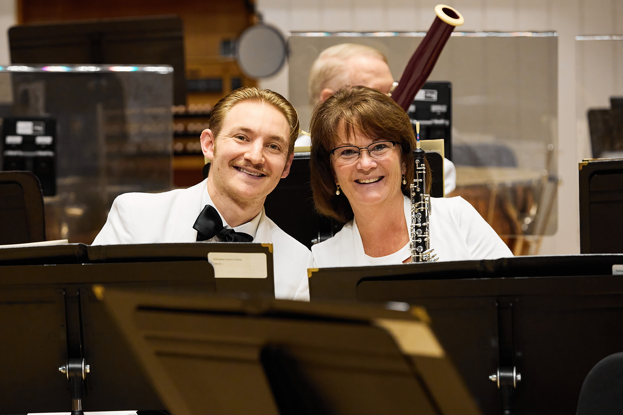 Photo of two orchestra members smiling.