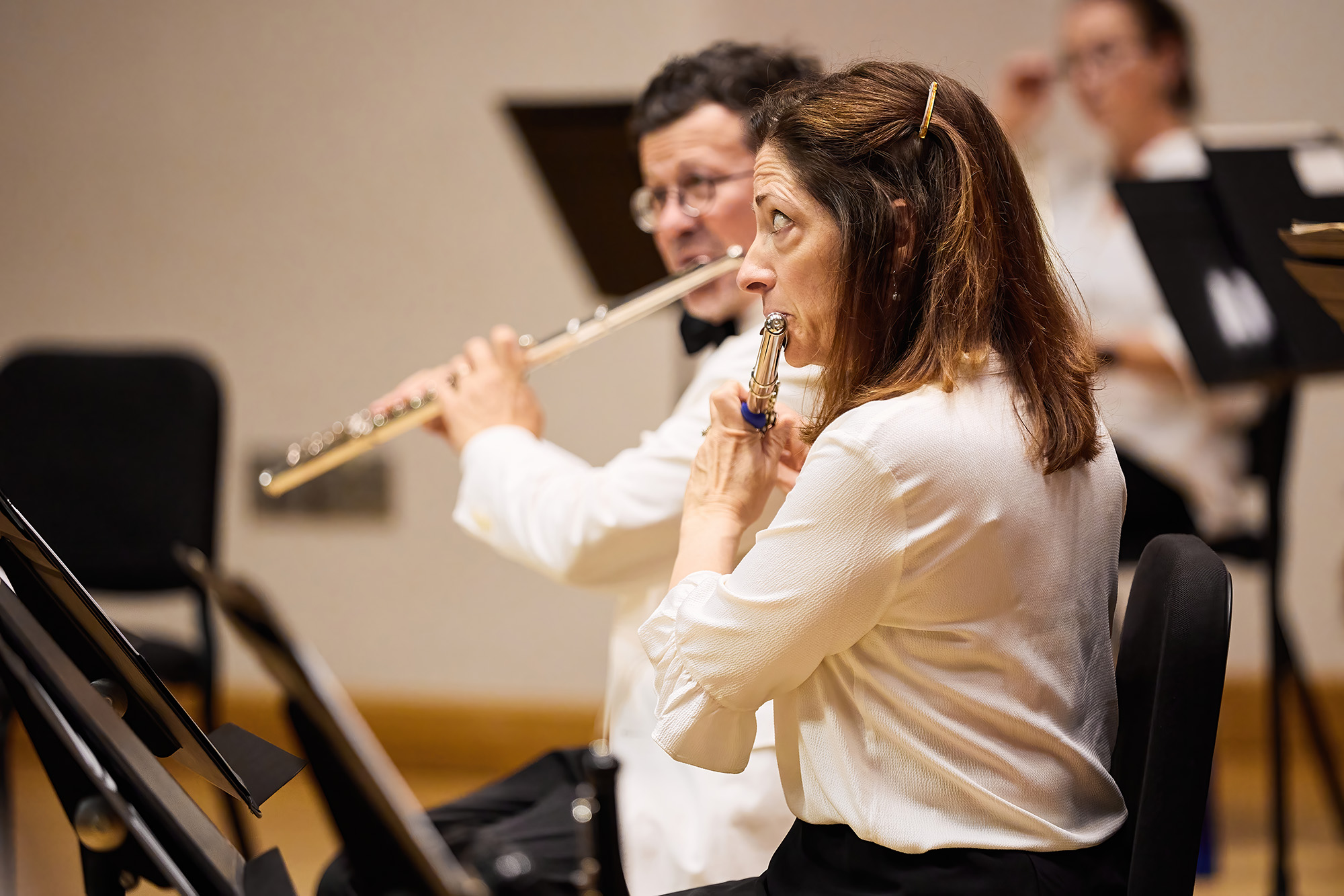 Photo of an orchestra member playing the flute.