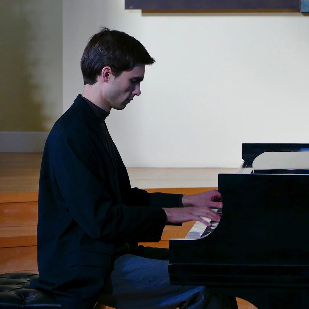 Photo of Cole Anderson playing piano.