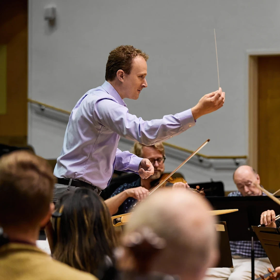 Photo of Conducting Fellow, Ryan Dakota Farris leading the Festival Orchestra.