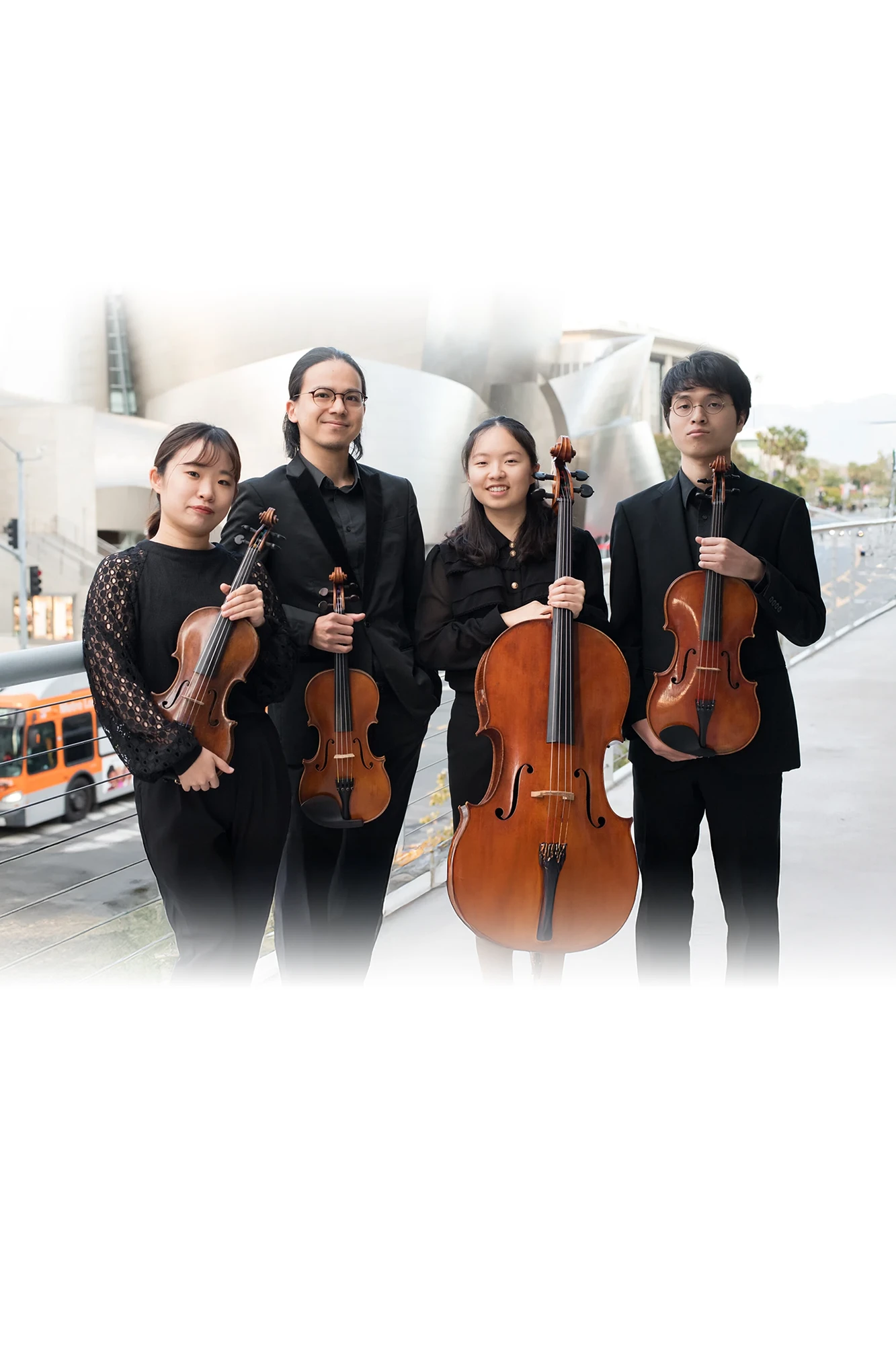 Photo of the four members of the Quartet Integra dressed in black and holding their instruments.