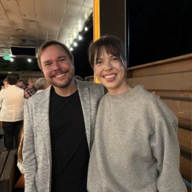 Marcelo and Tessa smiling together during an outdoor evening reception in Bellingham.