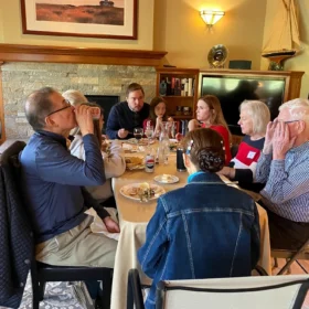 Guests, including Marcelo and his daughter, gathered around a dining table for a private dinner event in Bellingham.
